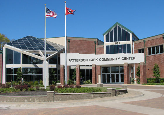 Exterior Patterson Park Community Center. Brick structure with large window panes making up the entryway.

American flag and Tennessee State flag flying on poles.